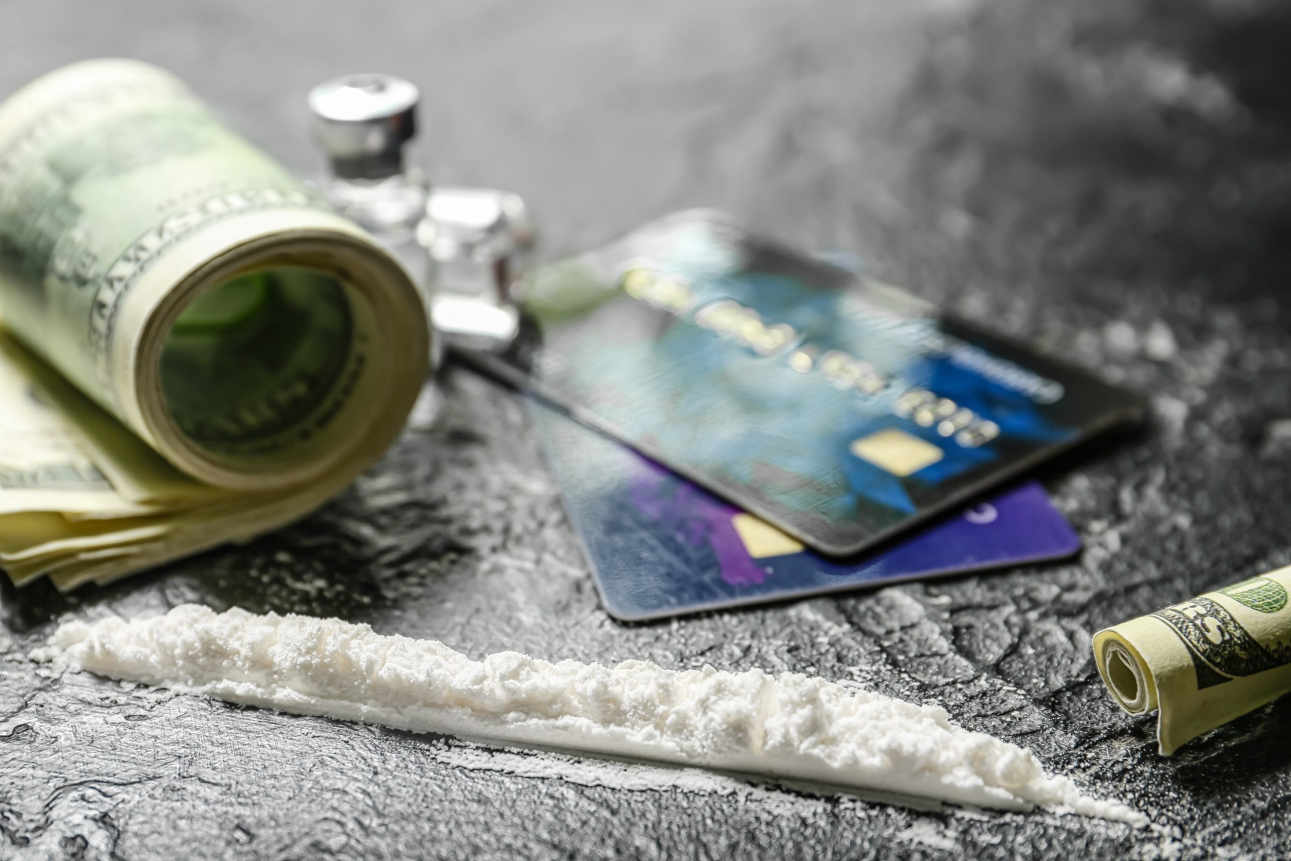 Cocaine and money on dark background