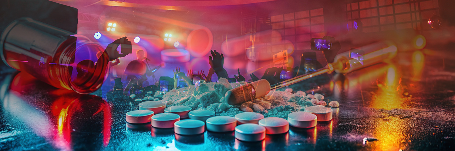 MDMA Pillen, Drogenspritzen und Fläschchen vor tanzenden Menschen in einem Club